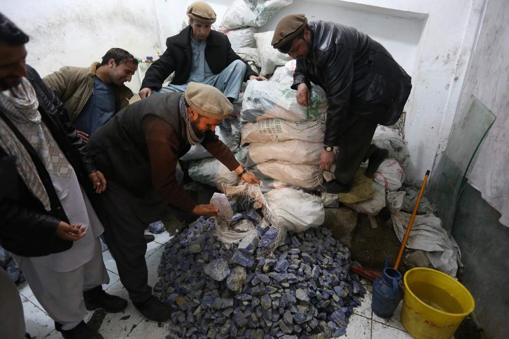 Afghan businessmen check lapis lazuli in the city of Kabul, Afghanistan. Credit: AP Photo\/Rahmat Gul